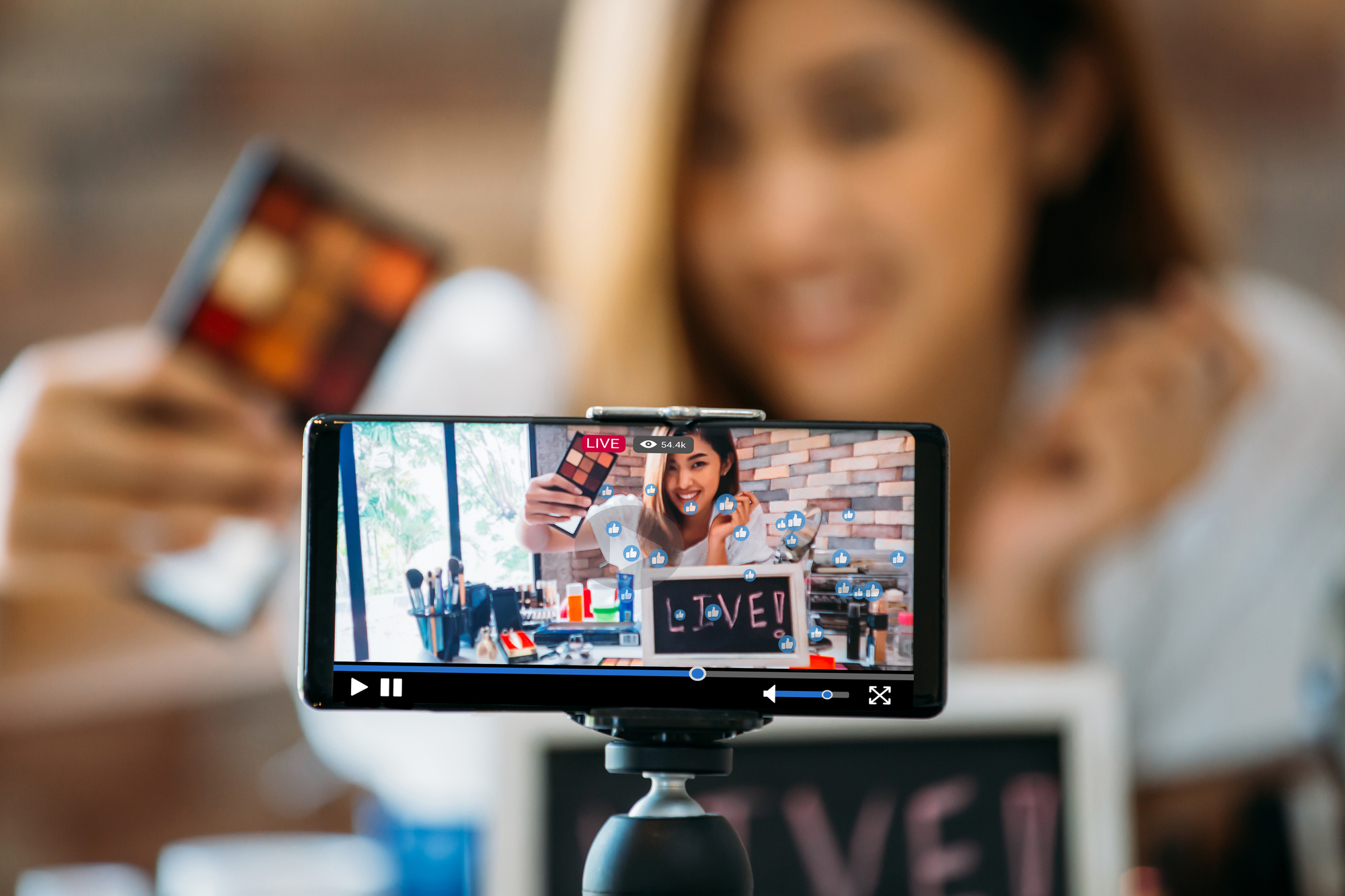 A woman is livestreaming to connect with her audience.
