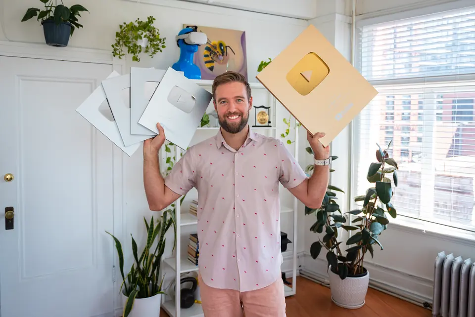 Holding up the Gold Play Button in the Vireo office